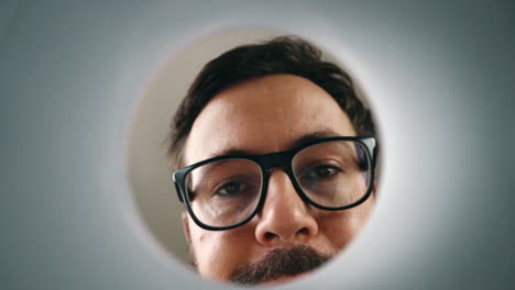 male face looking into coffee cup view from cup in dislike