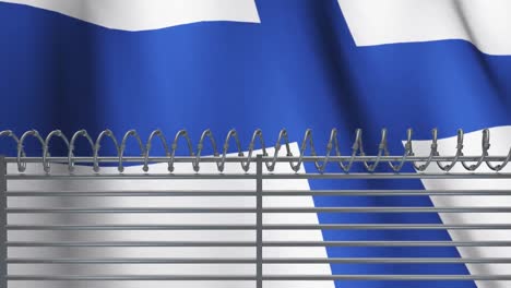 una valla de alambre de púas contra la bandera finlandesa ondeando