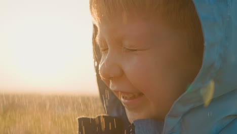 boy tightens gaze under drizzling rain child revels in refreshing sensation of water caressing face