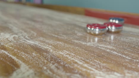 a static shot of a puck sliding into view and spinning at the end