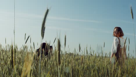 photographer capturing a portrait of a woman in a wheat field