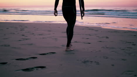 surfer on the beach at sunset