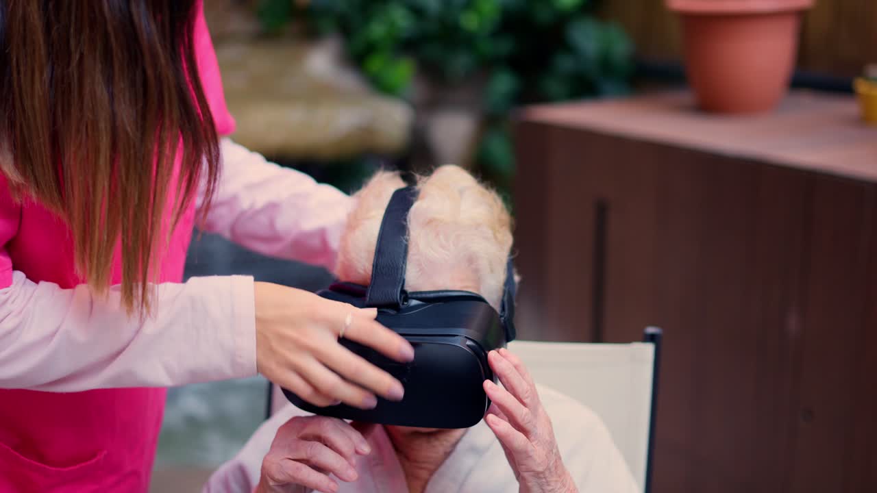 Elderly Woman Experiencing Virtual Reality with Caregiver Assistance