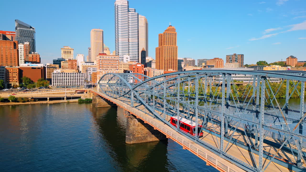 Traffic on the Smithfield-street Bridge in Pittsburgh, Pennsylvania, USA. Drone footage over the river revealing view on the national historical memorial on sunny day