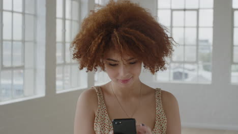 portrait of cute young woman using smartphone texting browsing online social media messages sending sms on mobile phone technology in apartment room