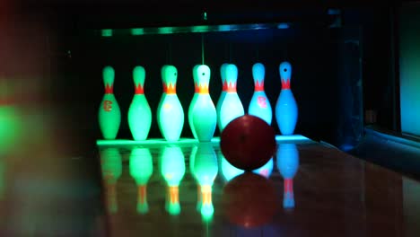 a powerful strike at a bowling alley in slow motion