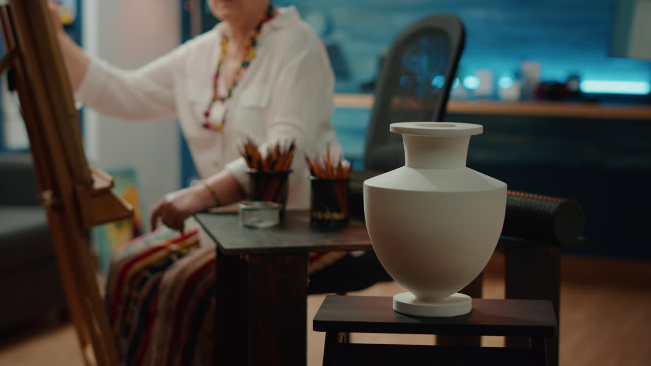 Authentic vase model on table with pencils and artistic tools