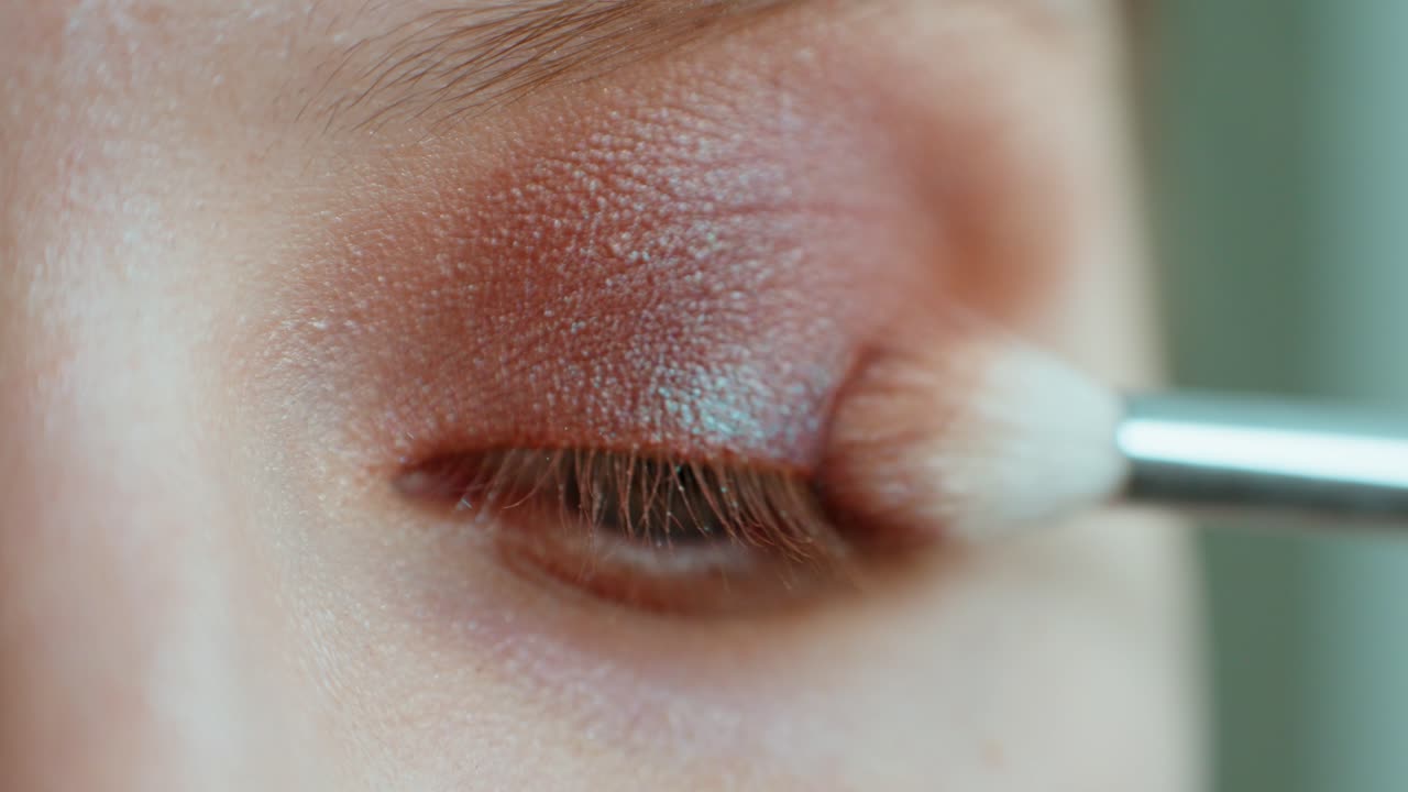 Applying brown eyeshadow