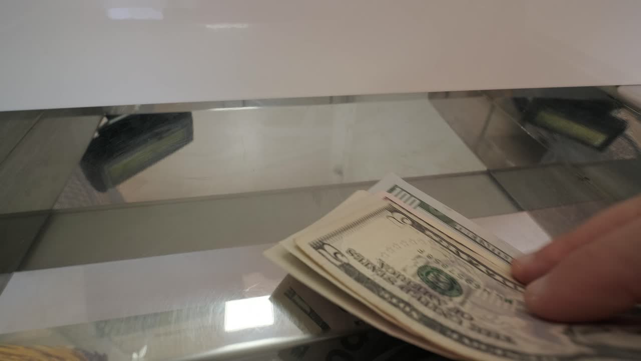 Hand Delivering Banknotes to Cash Register for Exchang