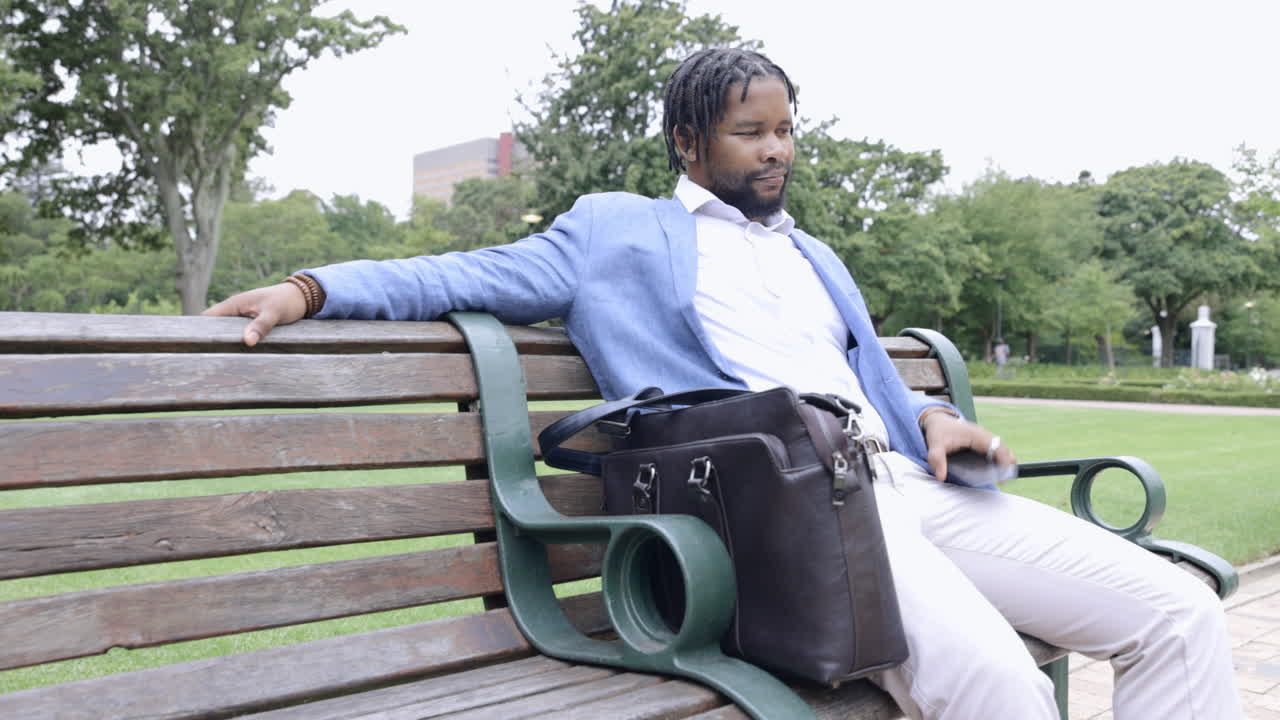 Business, park and black man on bench