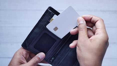 person holding an open wallet with credit and debit cards