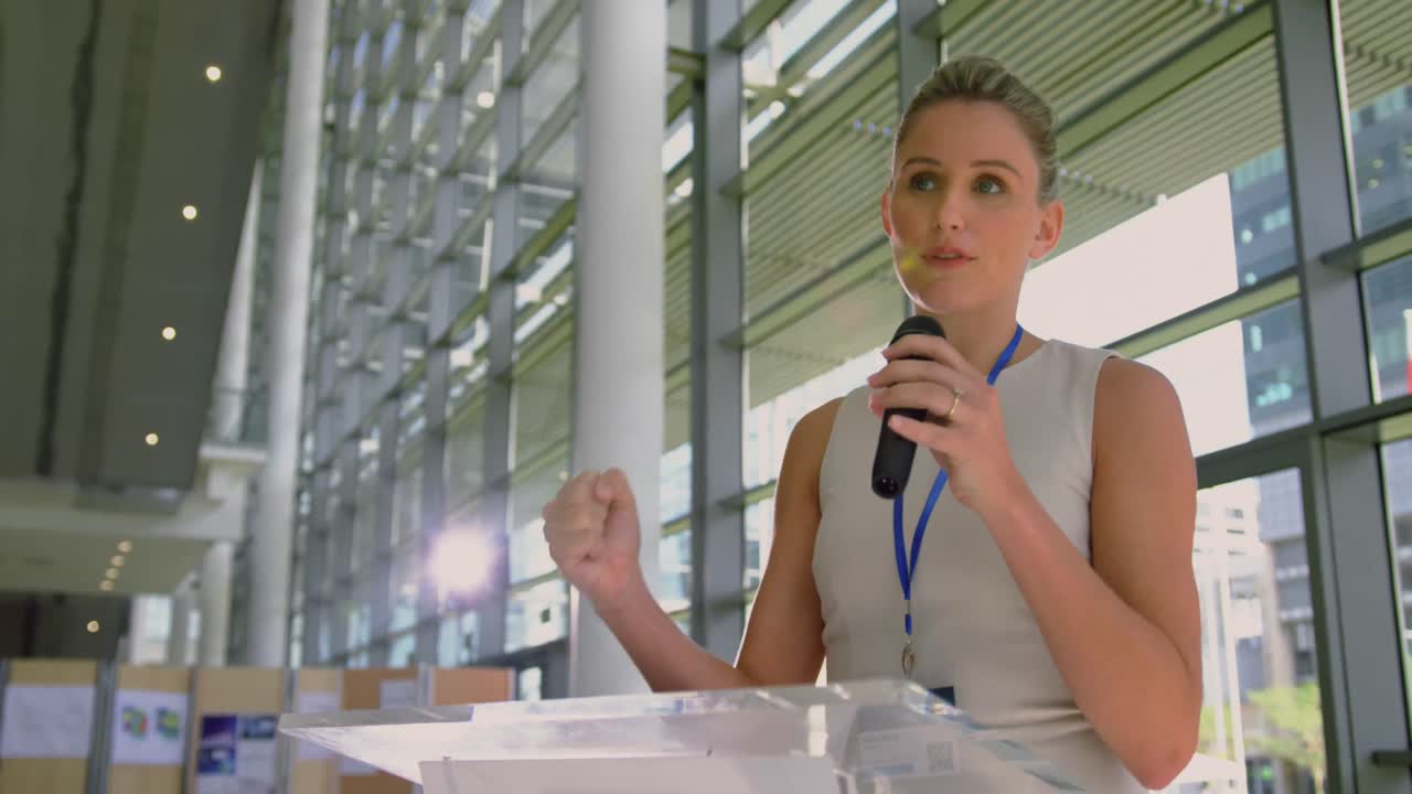 female speaker speaks in a business seminar at modern office 4k