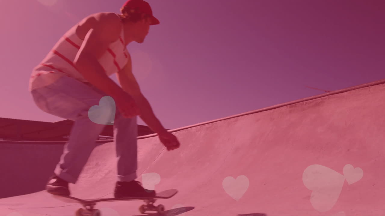male skateboarder crouching on skatepark bowl, driving sports marketing with pink heart overlay