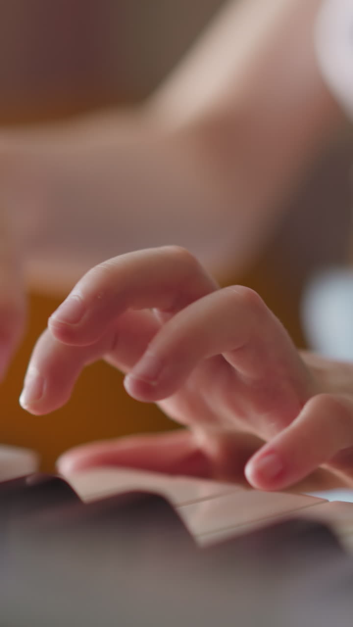 Girl with spinal injury plays piano at home. Skillful kid performs musical composition with steady flow between notes closeup on blurred background