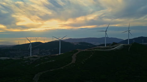 Wind-turbines-on-mountain-top-in-Spain-during-sunset,-aerial-view