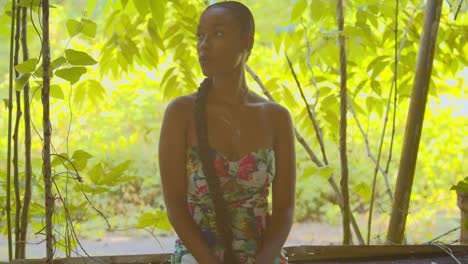 young girl looks fierce while sitting in the window of an old abandoned building