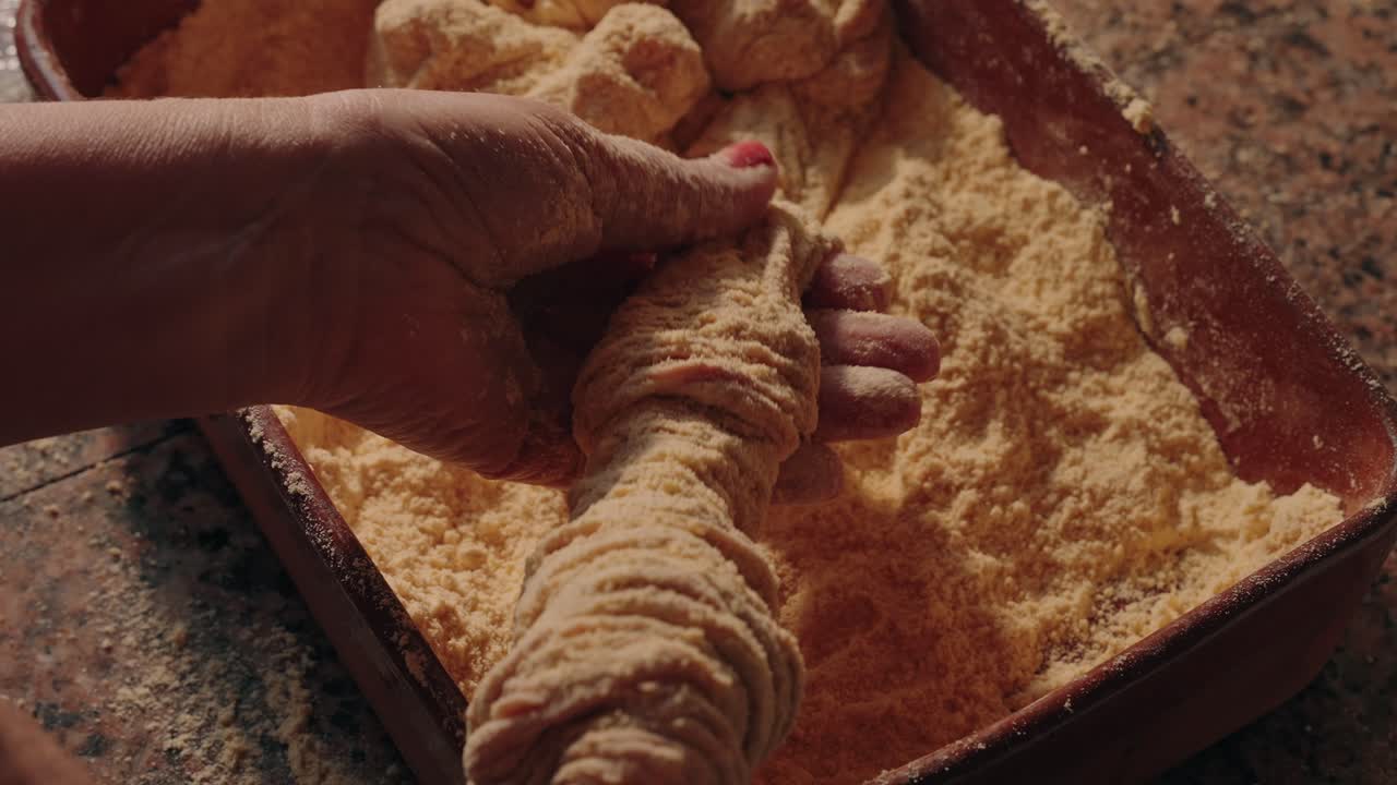 over the shoulder - Traditional pork intestines cleaned with flour by hand in Portugal