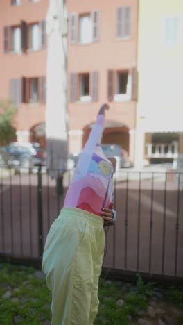 stylish woman in vibrant clothing in an urban setting