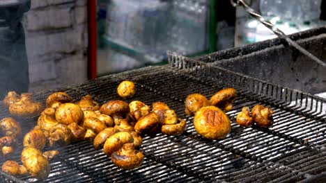 the cook prepares mushrooms on the grill. barbecue party