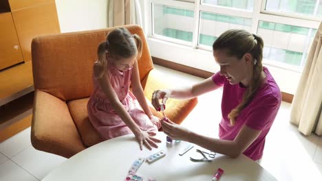 madre e hija pintando uñas