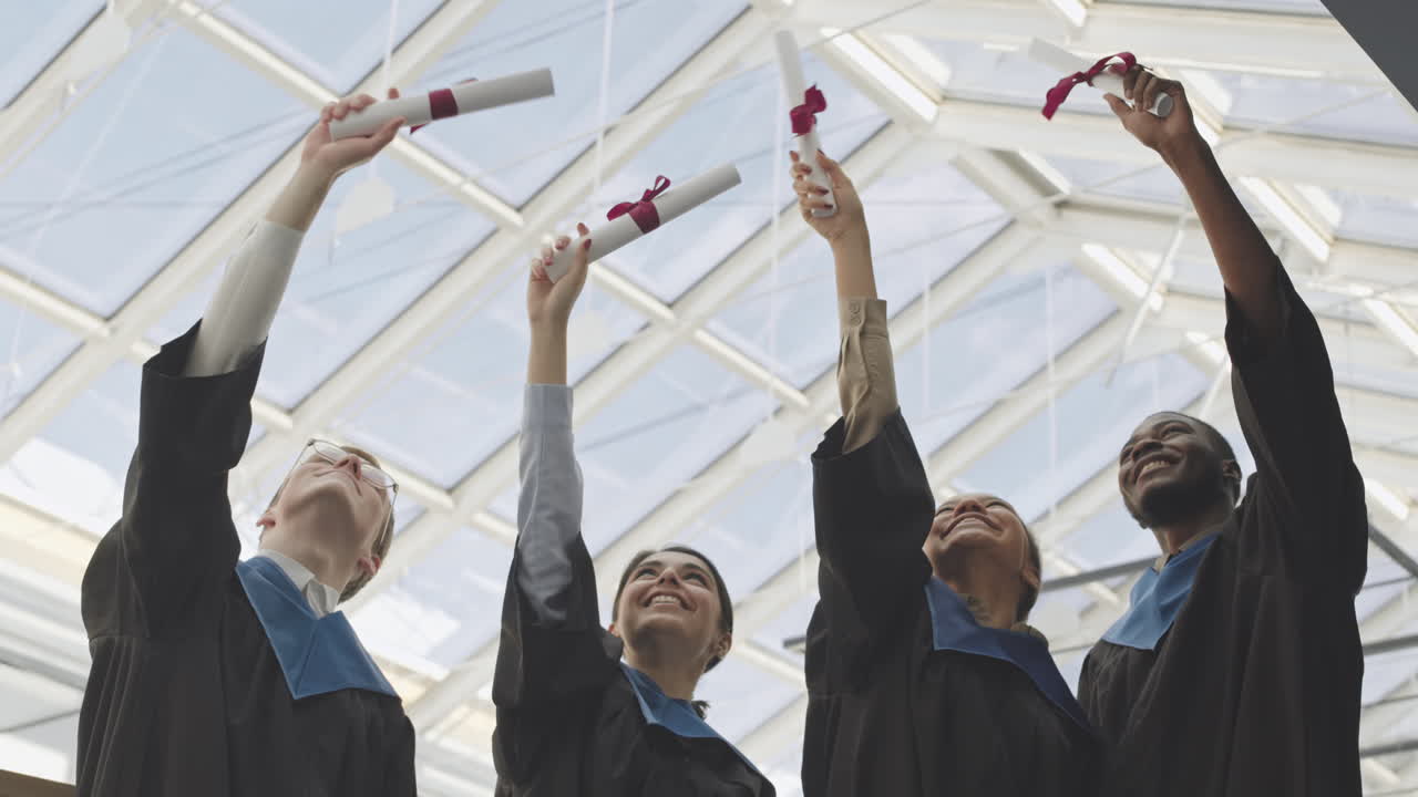 Four Diverse Cheerful Graduates