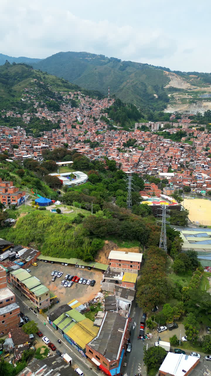 Aerial drone view of Medellin, historic hillside town in Colombia in daylight. Vertical