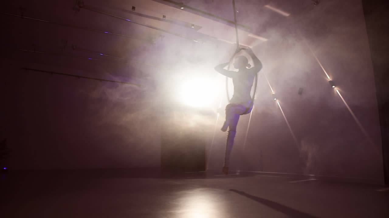 Athlete female dancer rotating with the hoop