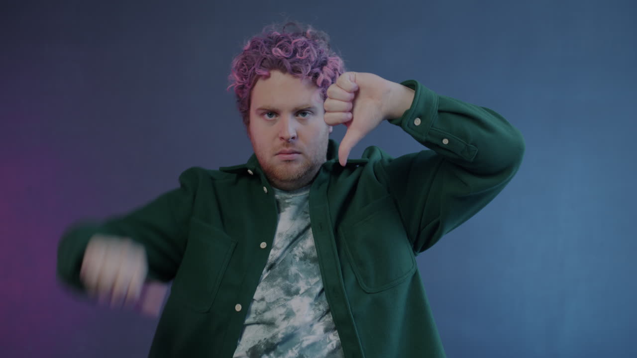 Man with Pink Hair Giving a Disapproving Thumbs Down