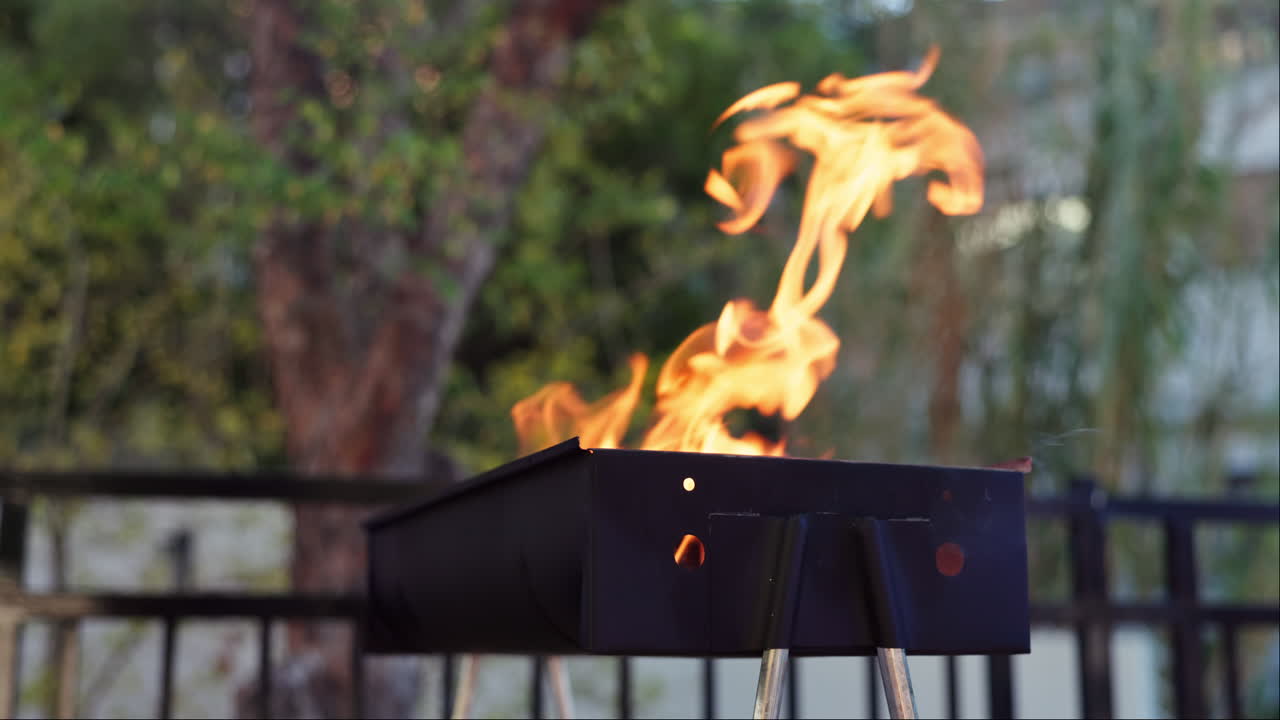 Barbecue grill with flames outdoors