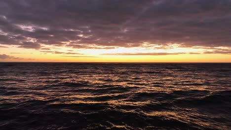 Aerial-orange-sunrise-with-sunlight-reflection-in-the-sea-in-Kapaa-Kauai