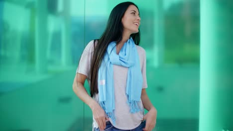 happy woman looking sideways in front of glass