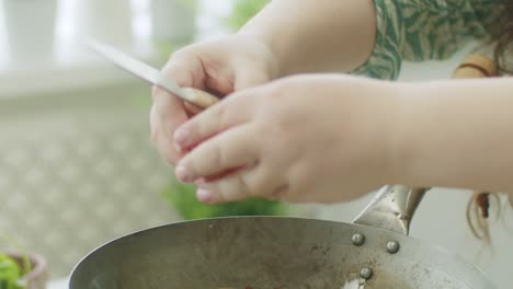 anonymous person frying eggs in pan