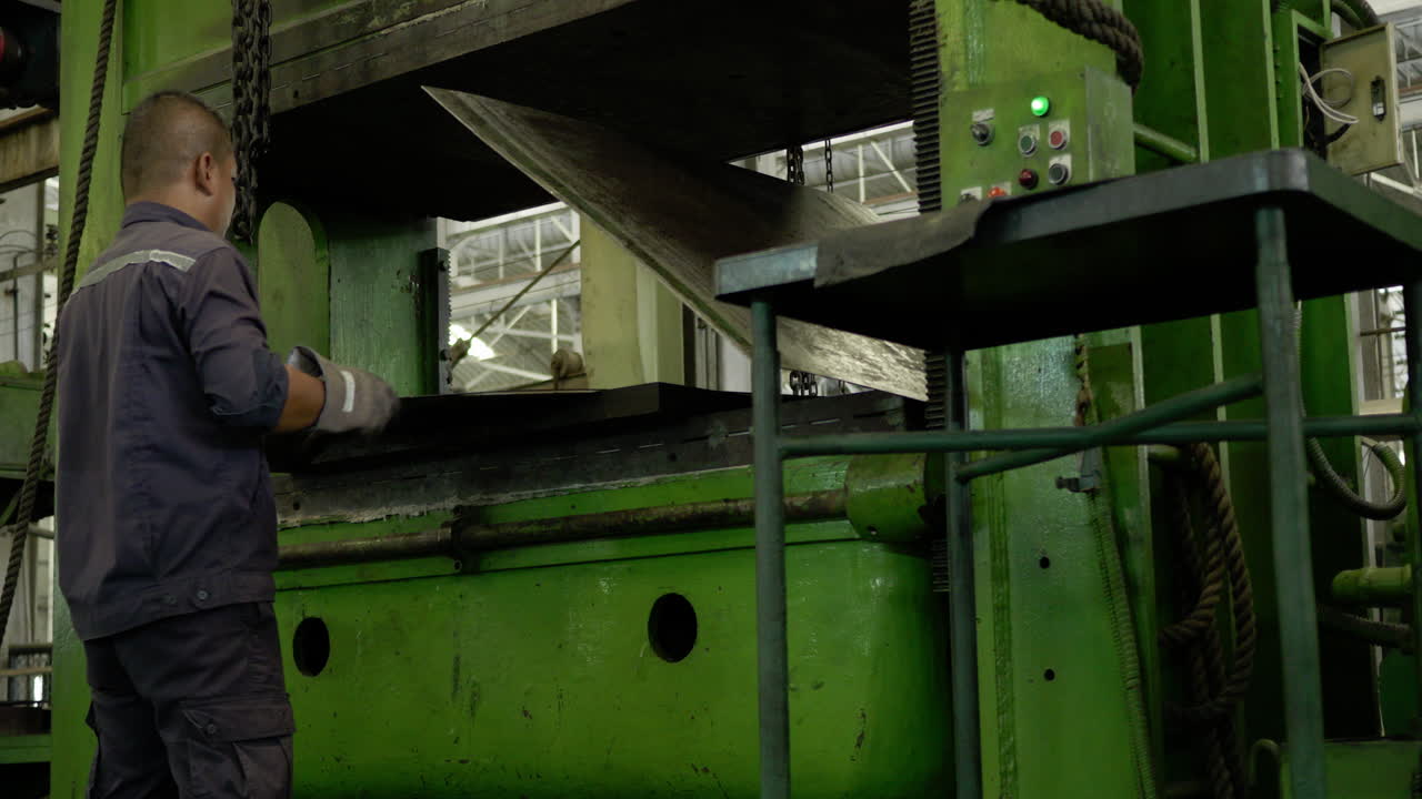 Shipyard workers use heavy machinery to flip rubber components of a ship. Industrial ship repair and maintenance operations showcasing technical expertise and precise handling of large scale equipment