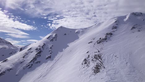 flying towards a mountain ridge in the snowy alps - dolly in shot - shot in tignes and val d'isere