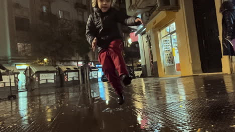 a child jumps into a puddle