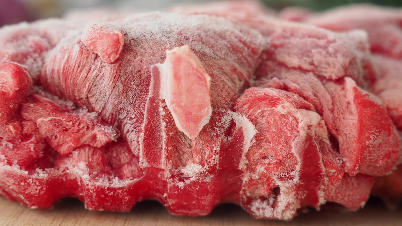 Primer plano de carne de res cruda congelada.