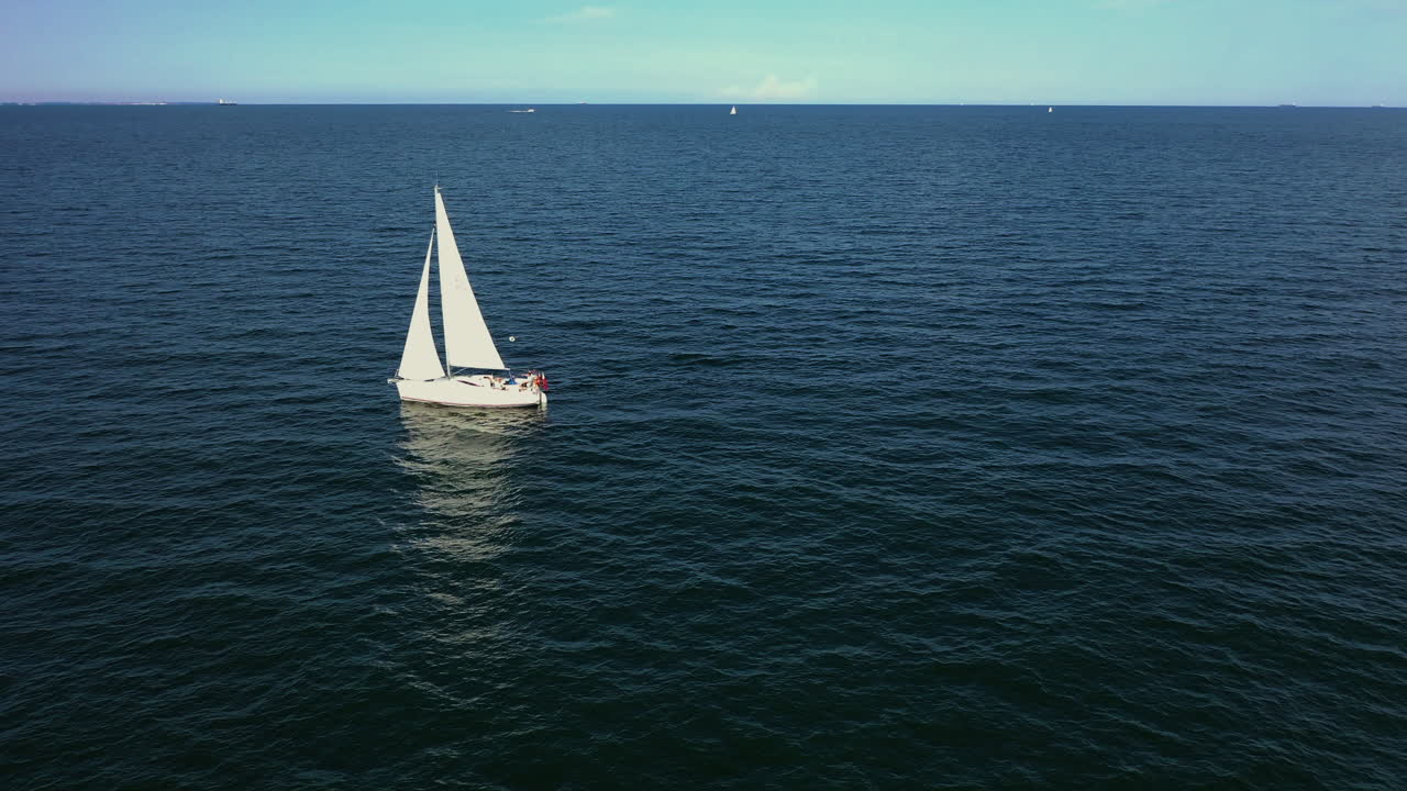 Aerial shot of drone flying above the ship sailing on the Baltic sea near Gdynia
