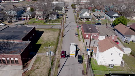 aerial footage following a recycling truck driving down the street in chattanooga, tennessee.