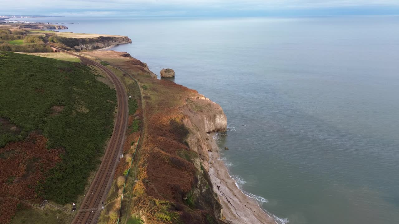 North East Coast Railway Line with Shippersea Bay, sea stack and hawthorn viaduct in view. County Durham, UK