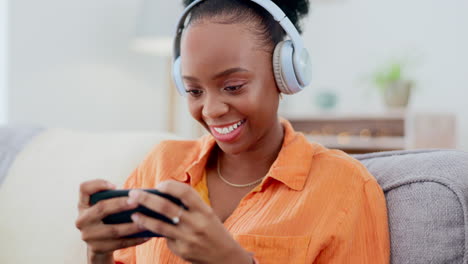 Phone-games,-headphones-and-black-woman-on-couch