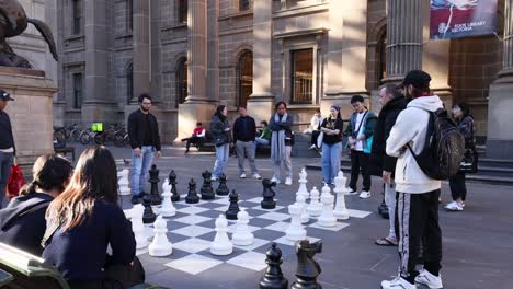 people playing giant chess in public square