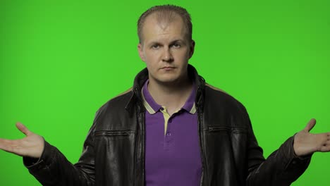 Confused rocker man looking around, making choice, difficult decision. Guy biker on chroma key