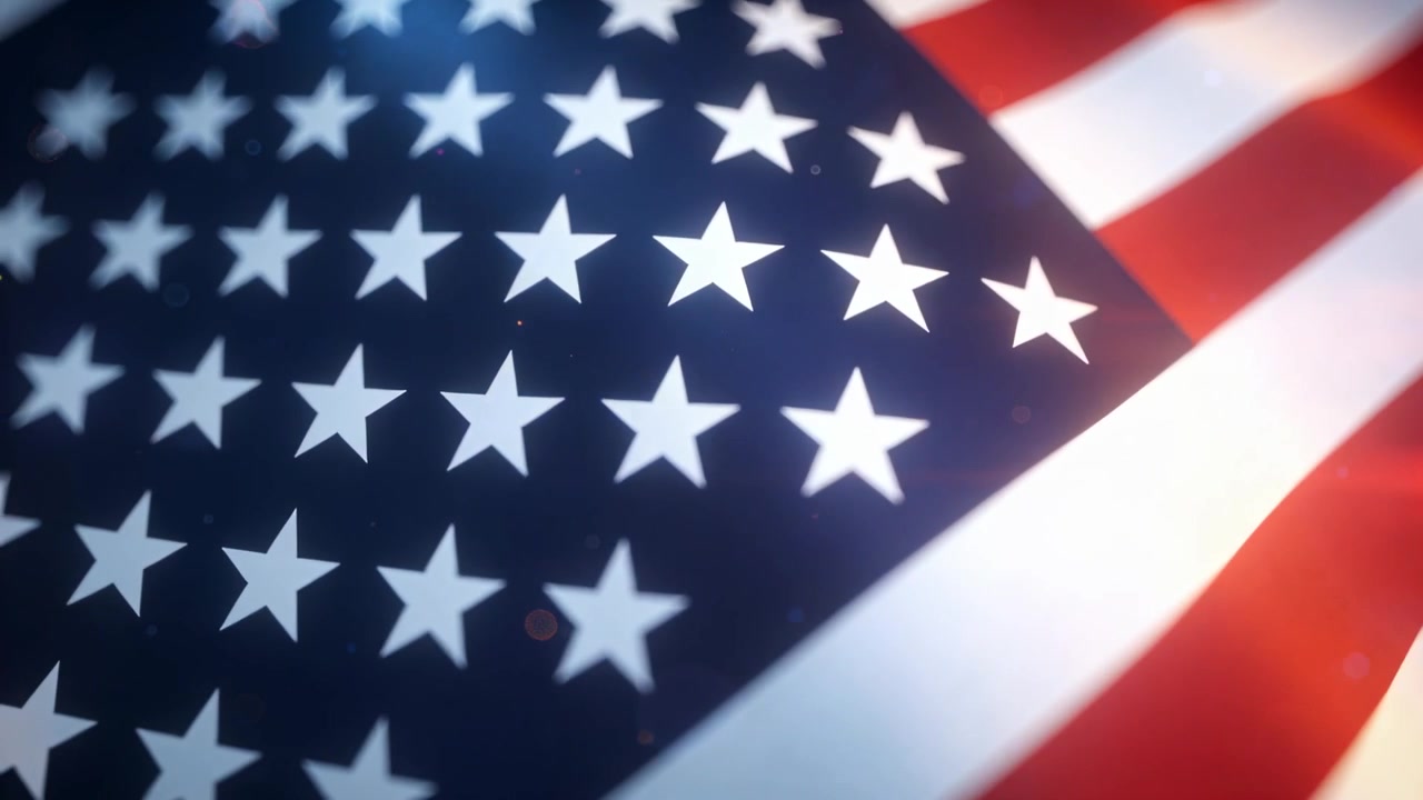 Pan revealing US flag shifting focus in studio closeup to emphasize stars stripes and lens flares