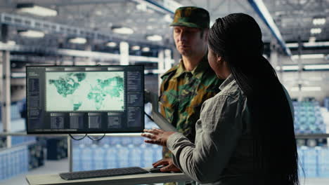 team of military specialists in data center looking at world map on screen