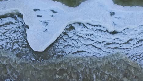 seaside icy waves in winter morning light