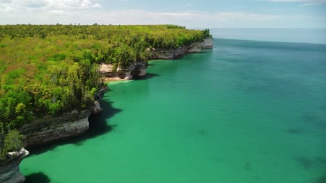 aerial lakeshore rock cliff fly out pan - pictured rocks national lakeshore, michigan