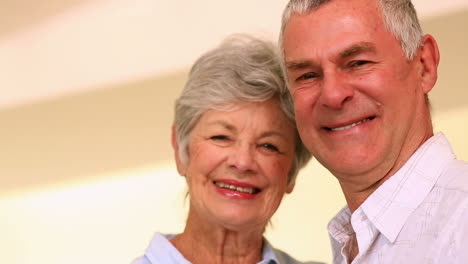 Happy-senior-couple-standing-and-embracing