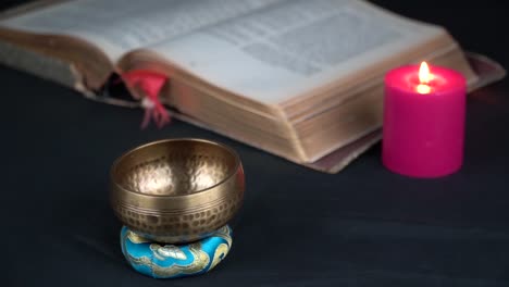 tibetan brass bell holy spiritual book and red candle