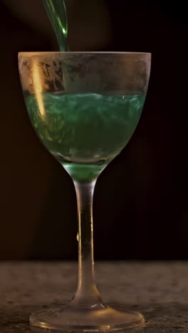 pouring a green cocktail