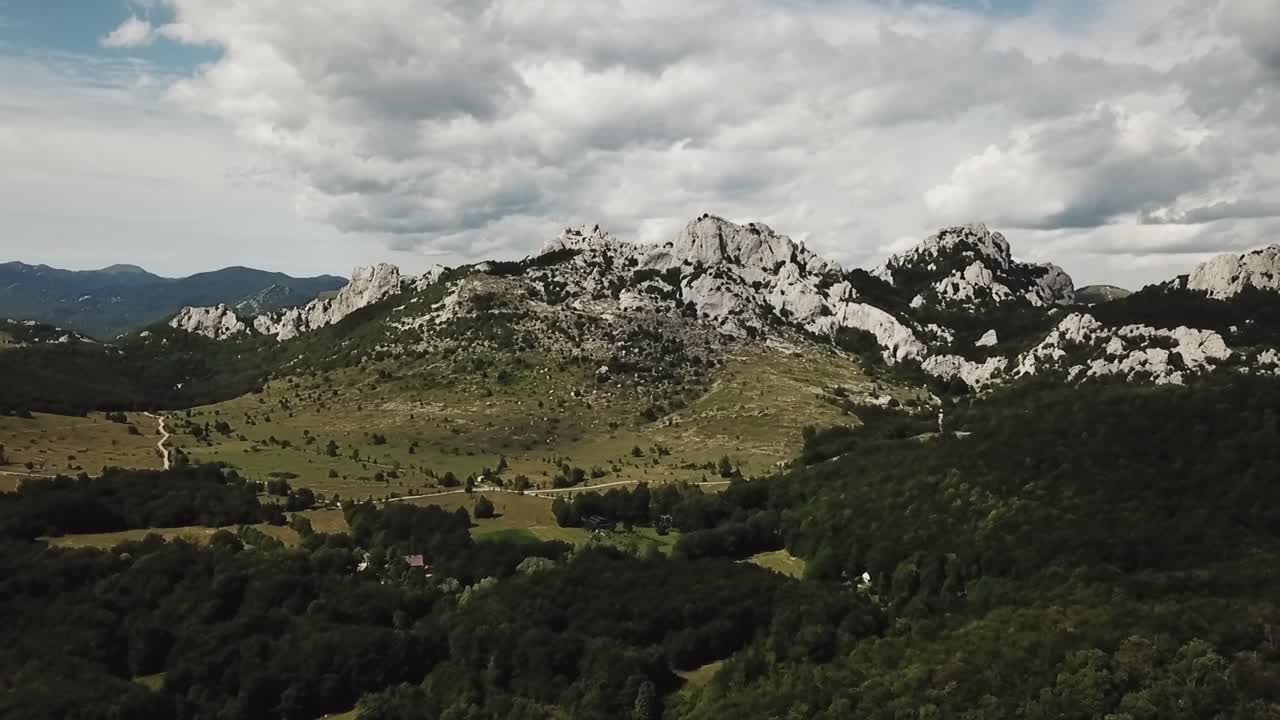 Imagens de drone das montanhas da Croácia, exibindo picos acidentados, vales profundos e paisagens alpinas intocadas, destacando a deslumbrante paisagem natural do país.